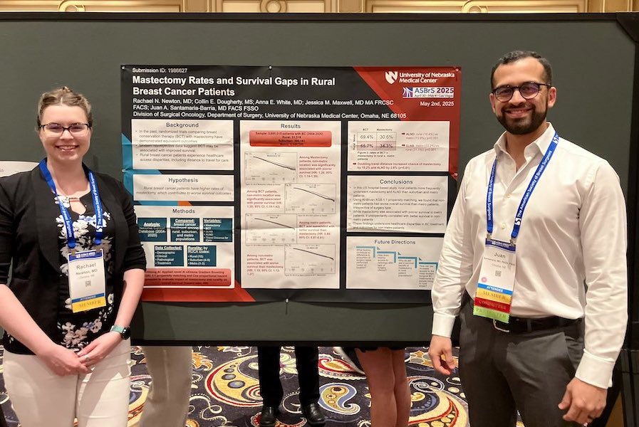 Researchers presenting a poster