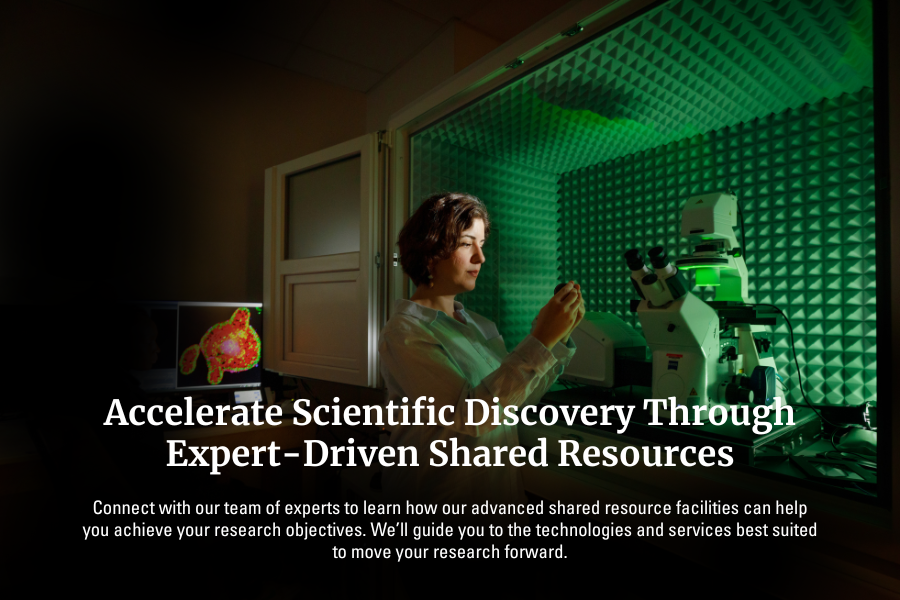 Exterior of a building with a sign reading "Suzanne and Walter Scott Cancer Research Tower"