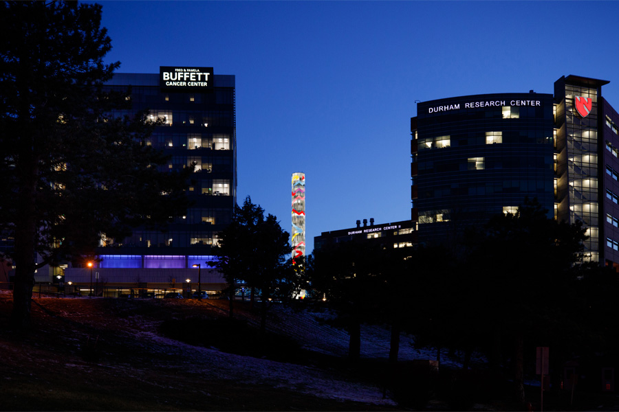 Exterior of the Fred and Pamela Buffett Cancer Center and Durham Research Center at night