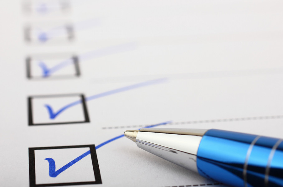 A sheet of paper with check boxes and blue check marks