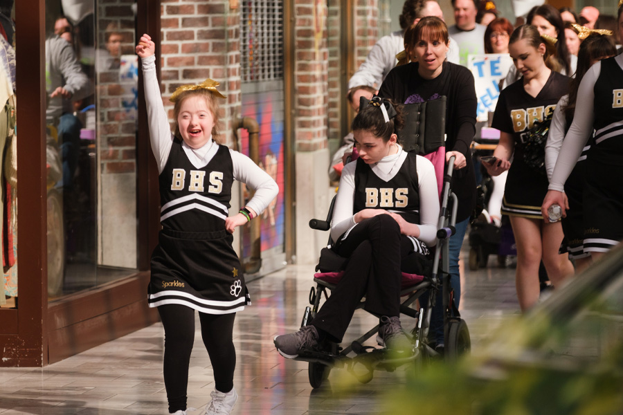 Participants walk in a mall during a fundraising event