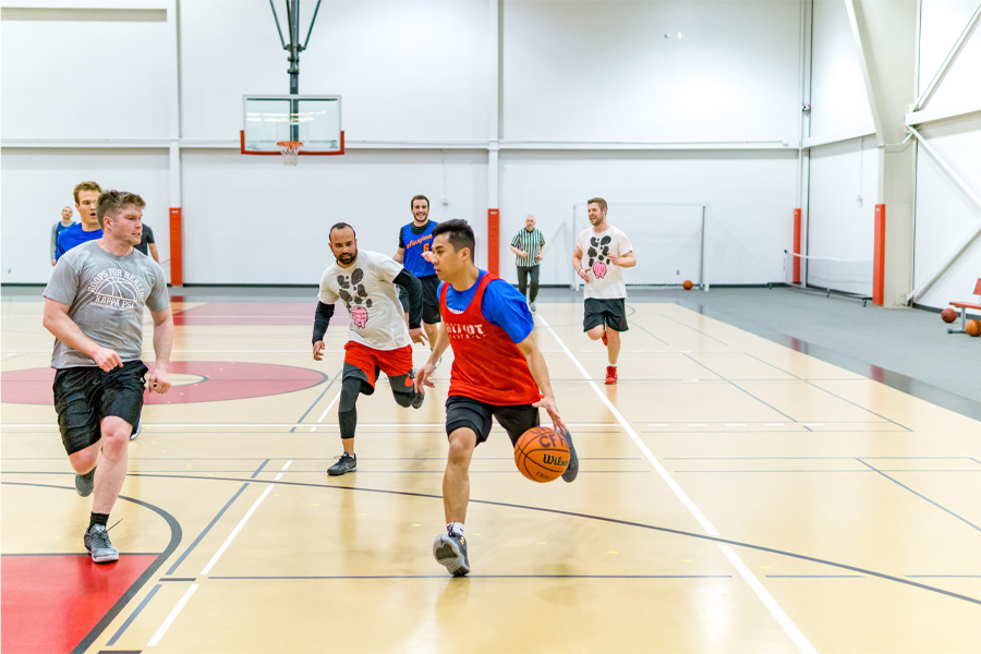 Students play basketball in a gymnasium