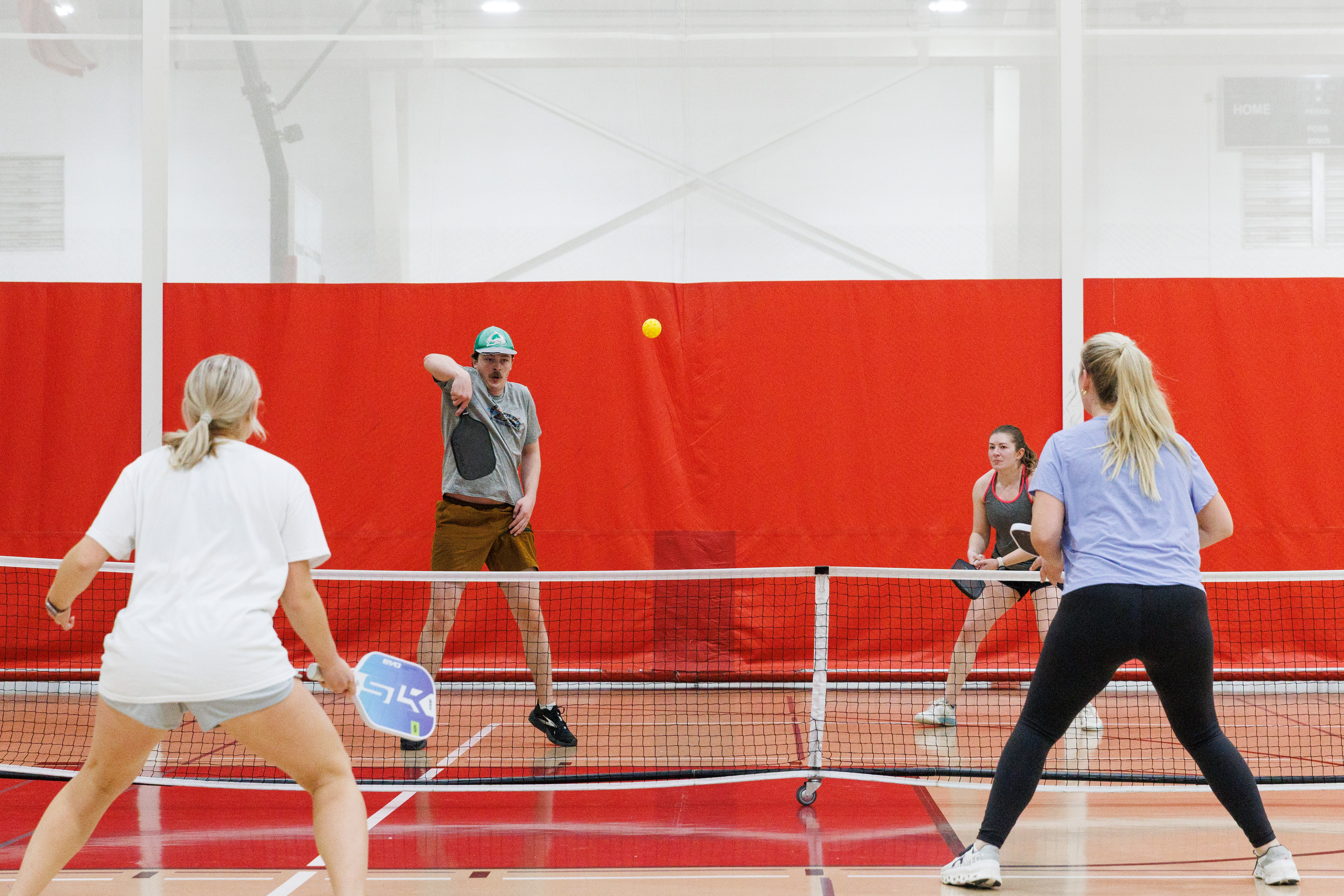 Intramural participants play pickleball in a gymnasium