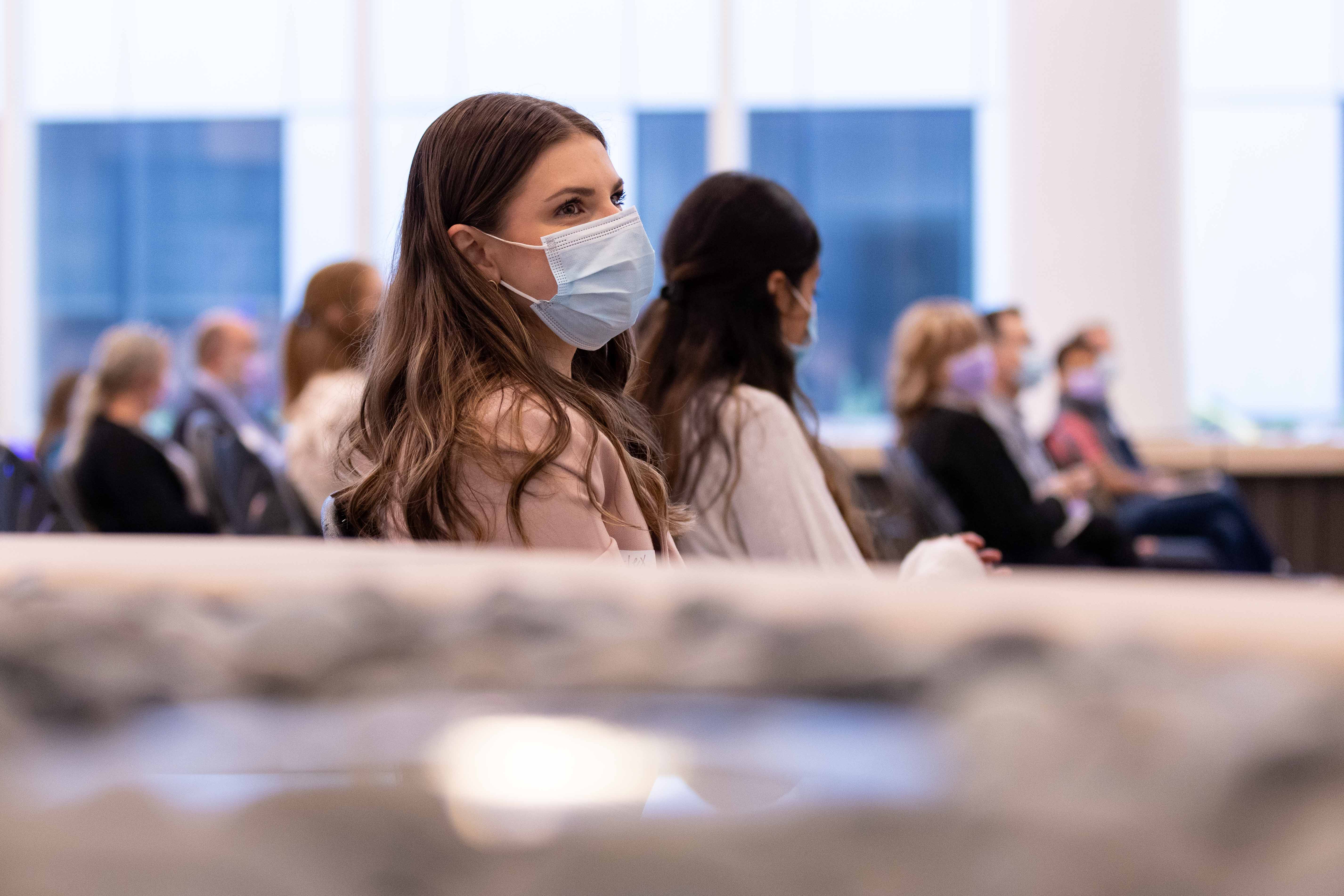 woman sitting in convention audience