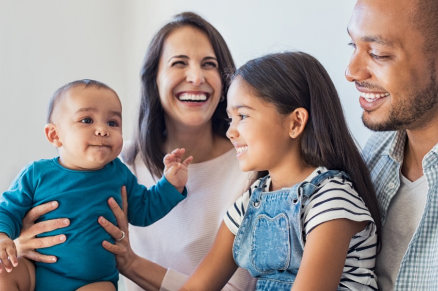 Young parents sitting with two children