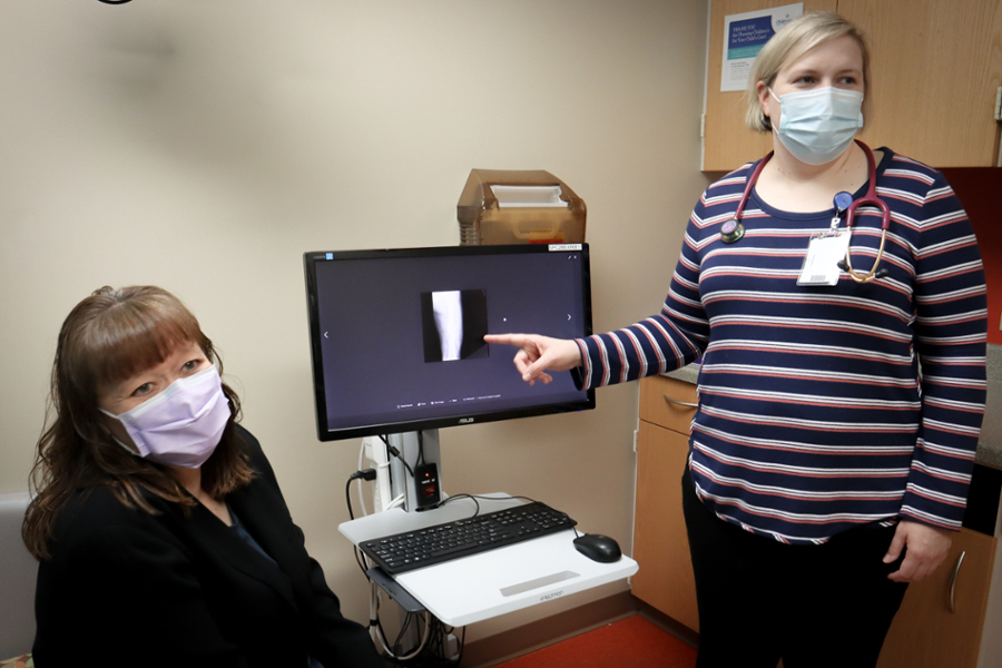 doctor, nurse, images on screen of bone