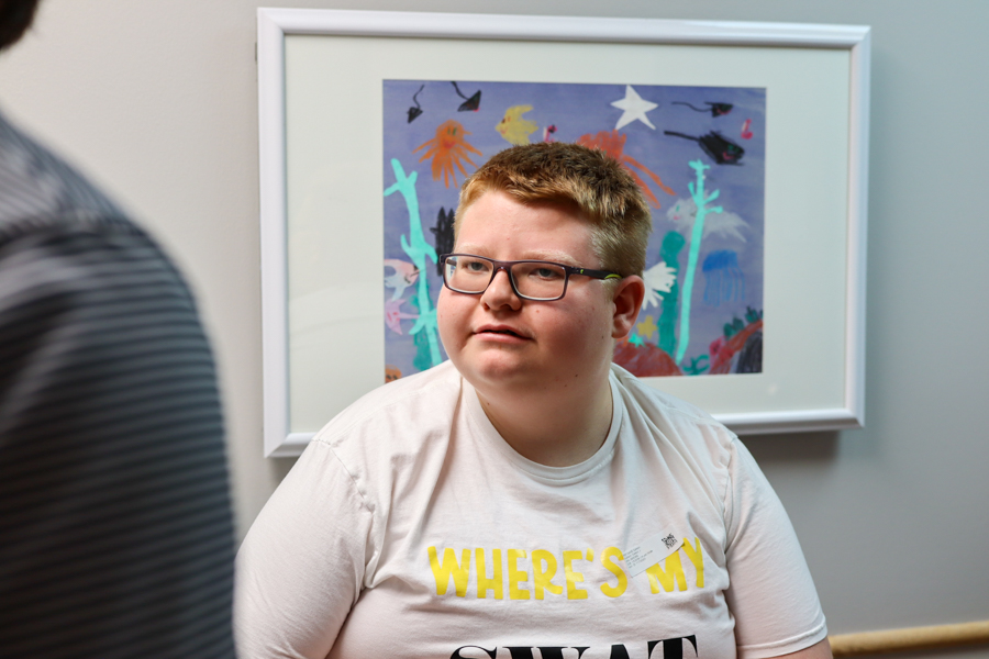 adolescent child sitting in clinical room