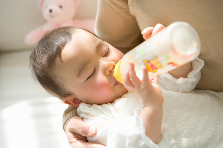 Asian baby drinking formula