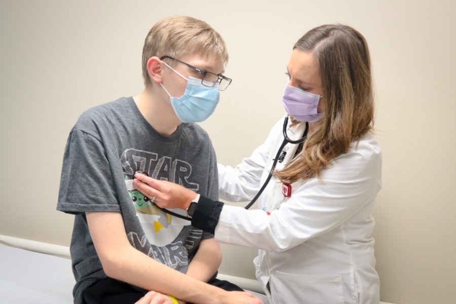 Doctor examining adolescent boy.