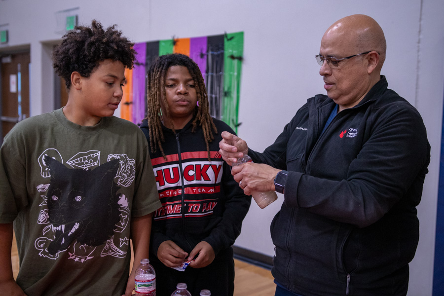 Doctor shows experiment to two NorthStar participants