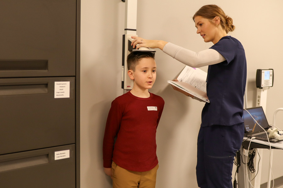 Nurse measuring height of child