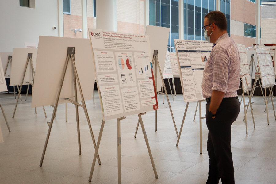 Man looks at scientific poster at poster exhibit