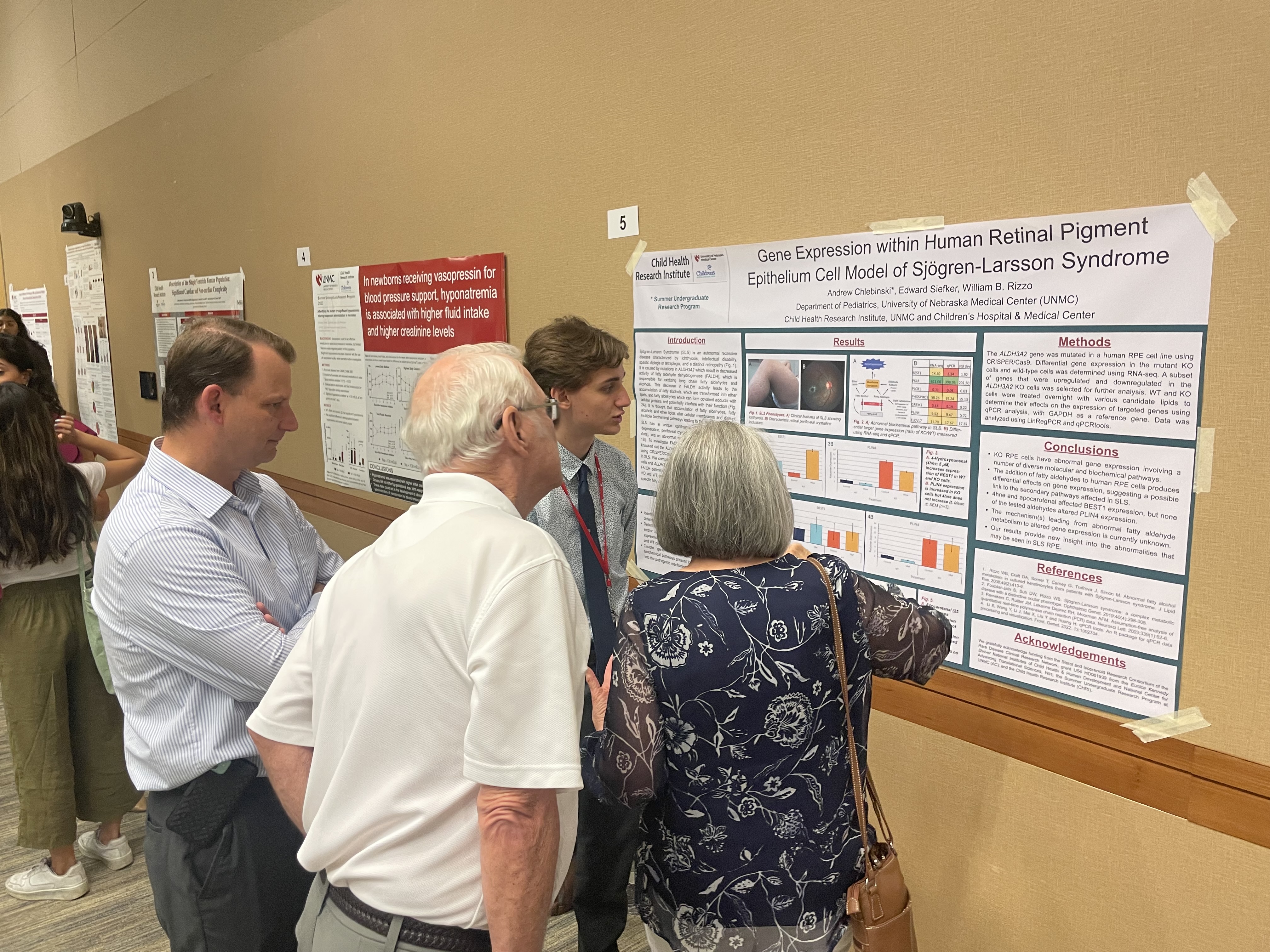 group of people looking at research poster