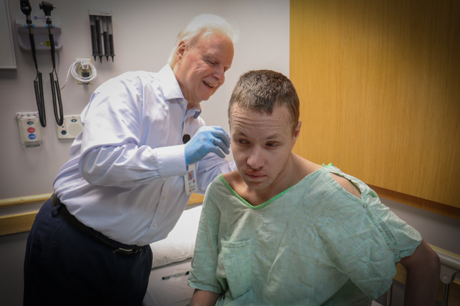 doctor examining male patient on examination  bed