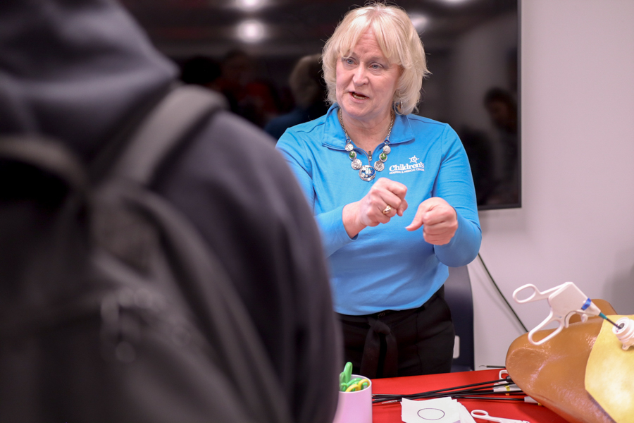 woman demonstrating surgical equipment techniques