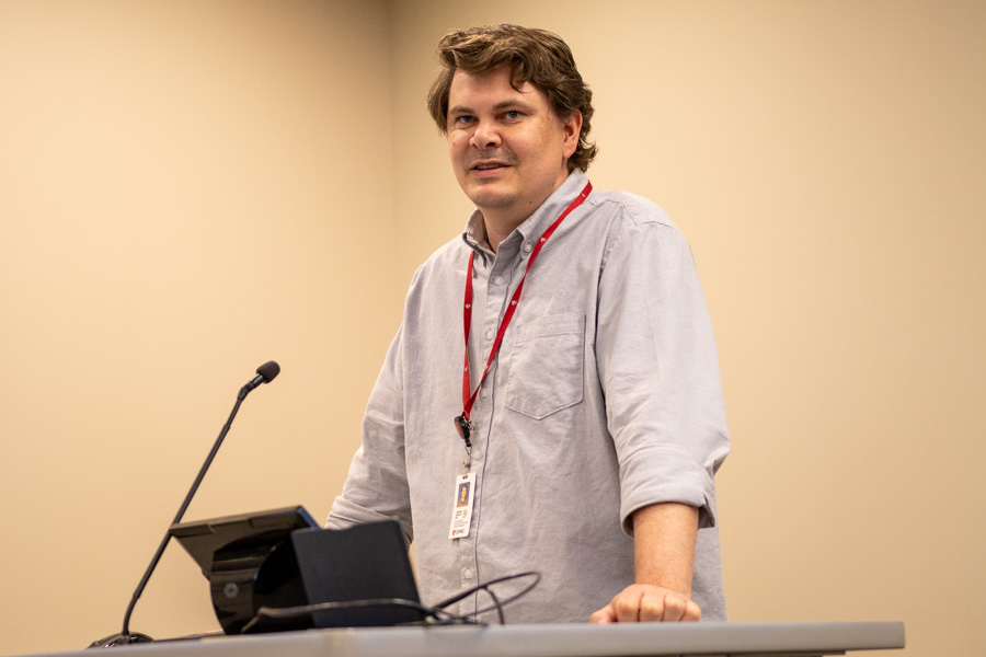 man speaks while standing at a podium