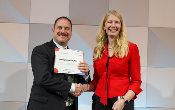 researcher receiving certificate from director of CHRI