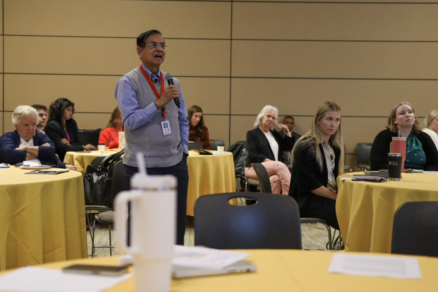 Man asking question of speaker at conference