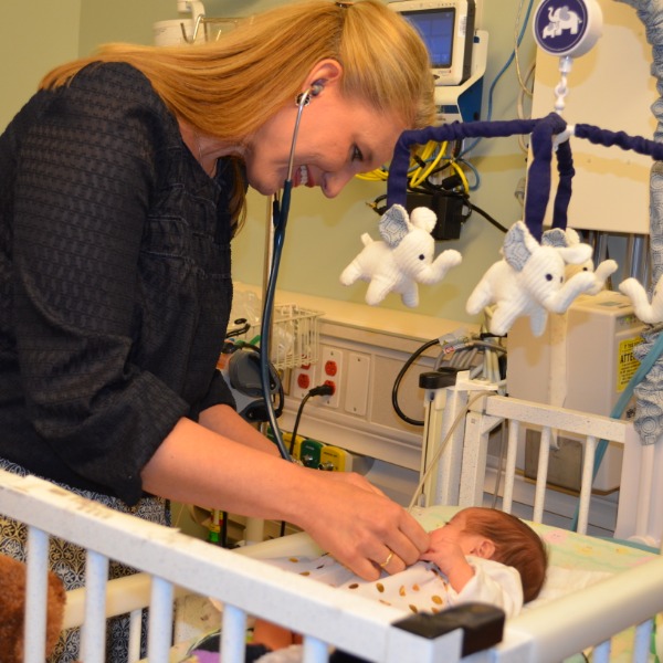 Dr. Anderson Berry Examining newborn baby