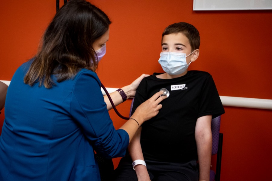Child being examined by doctor with stethoscope