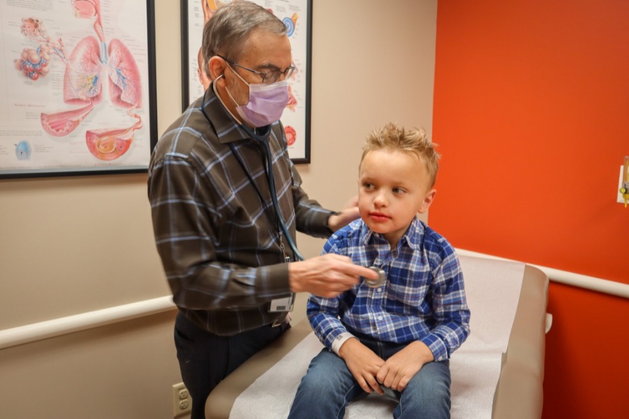 child being examined with stethoscope