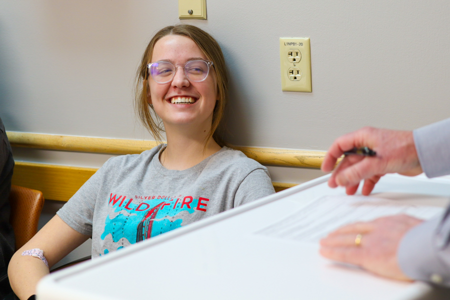 adolescent smiling up at researcher