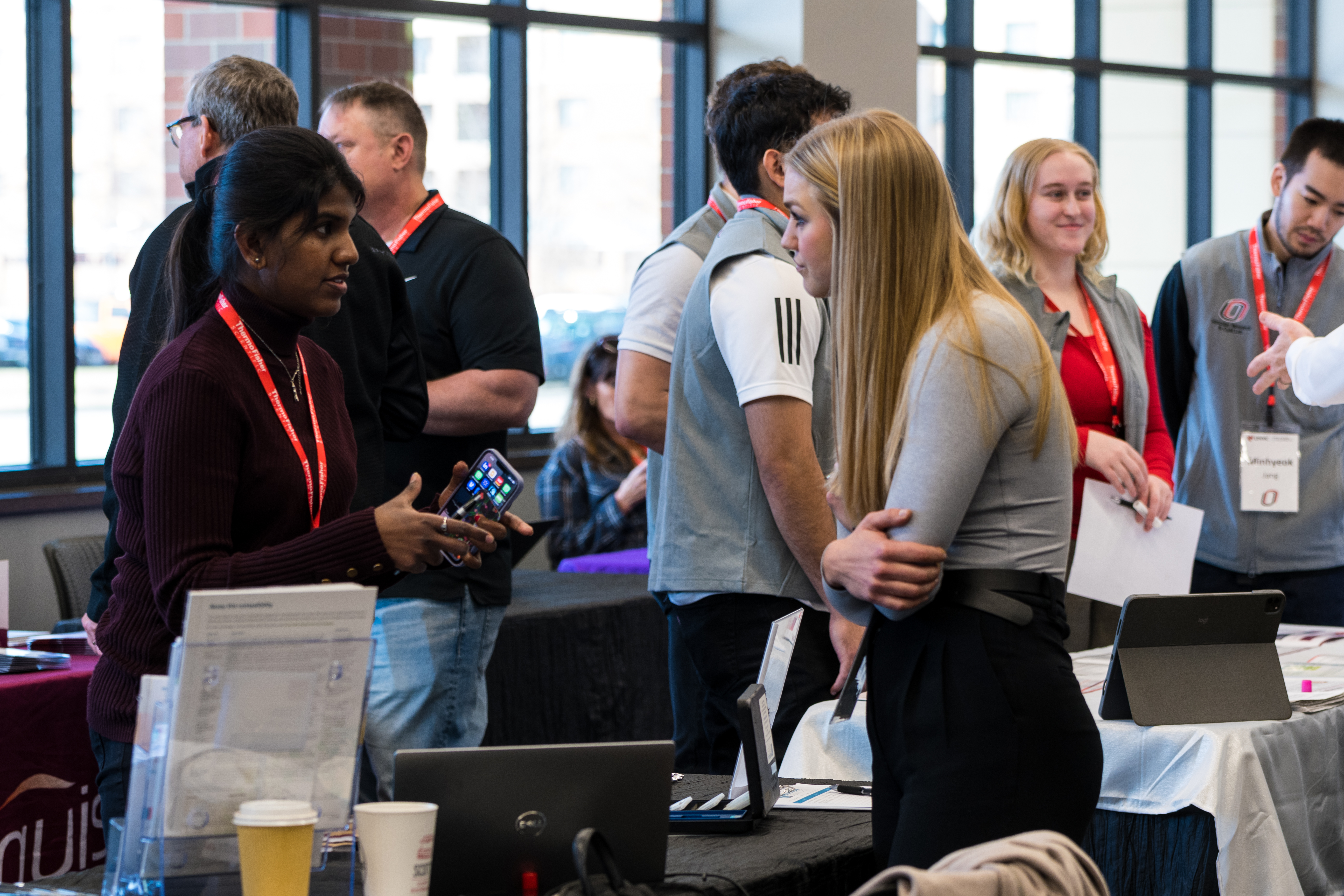 Group of people conversing in an event space.