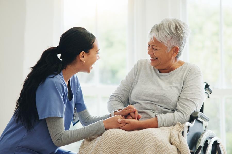 A nurse checks a patient's vitals.