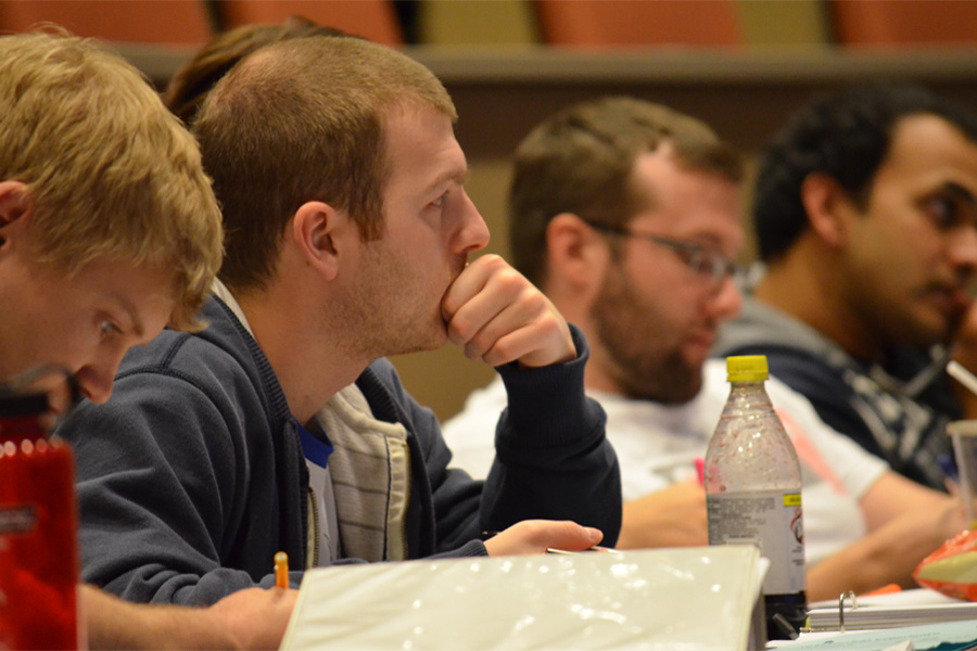 A group of medical students sit in a lecture hall