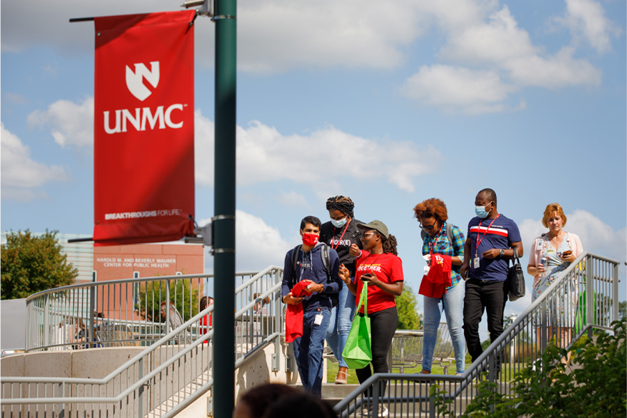 A group of students walk on the UNMC campus