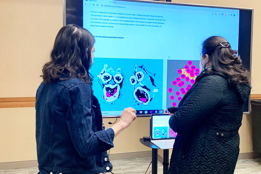 Two students look at a digital presentation