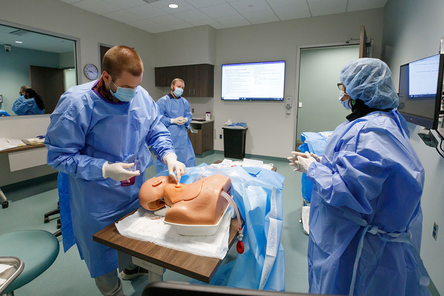 A fourth-year medical student practices simulated procedures.