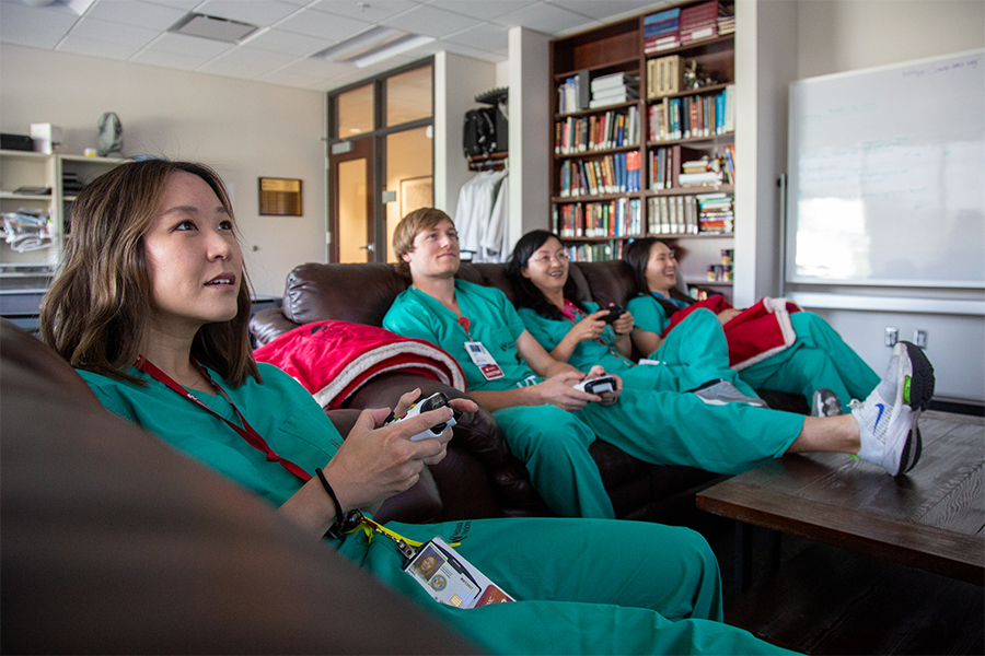 Ophthalmology residents enjoy downtime in their lounge with video games.
