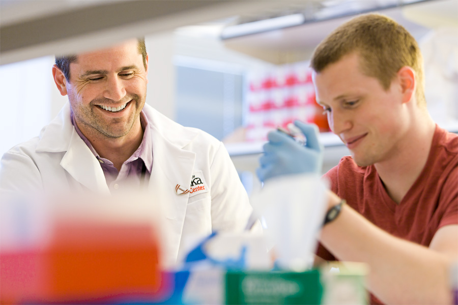 A physician and a student work in a lab