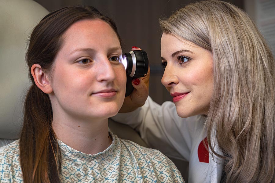 A dermatologist checks a patient