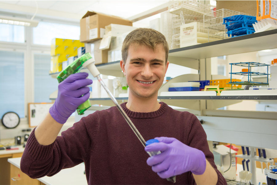 A researcher works with lab equipment