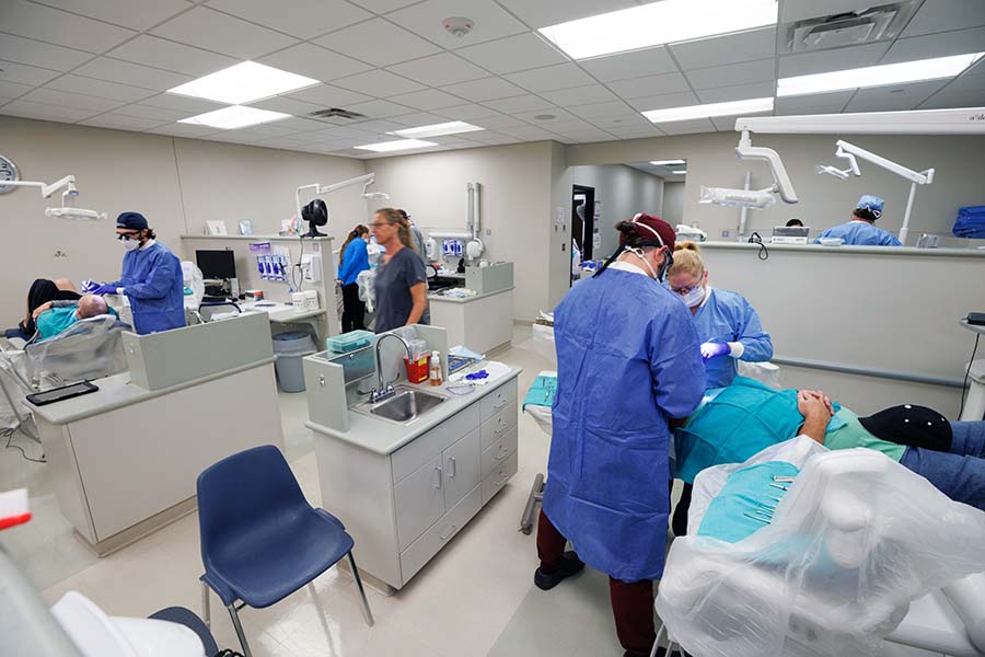 Dental students works with patients in the college's clinic.