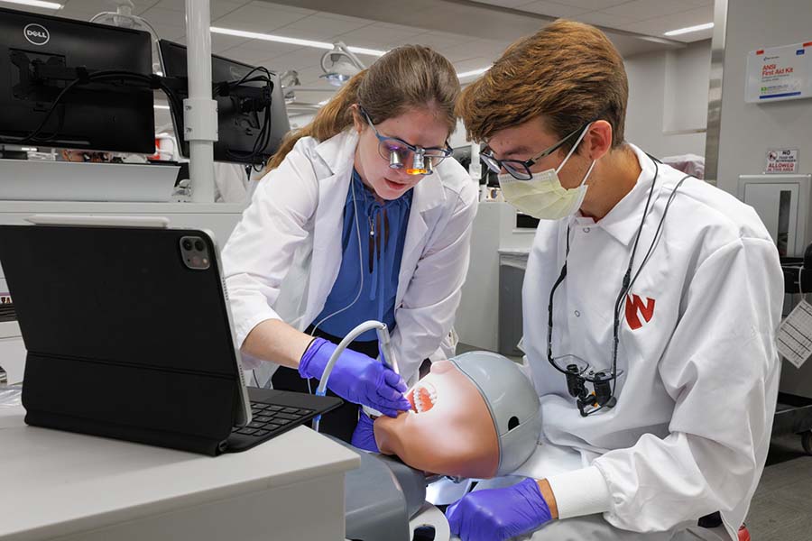 Two dentistry students work in the college's simulation clinic.