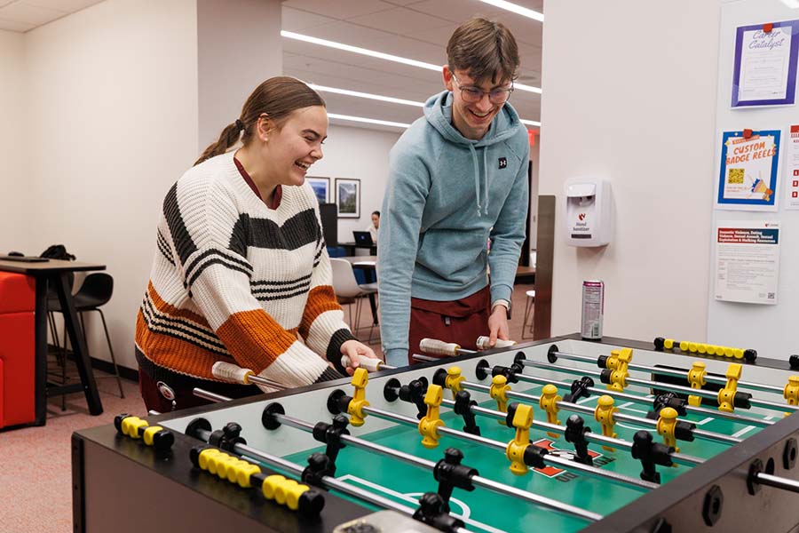 Two students play foosball in the College of Dentistry.