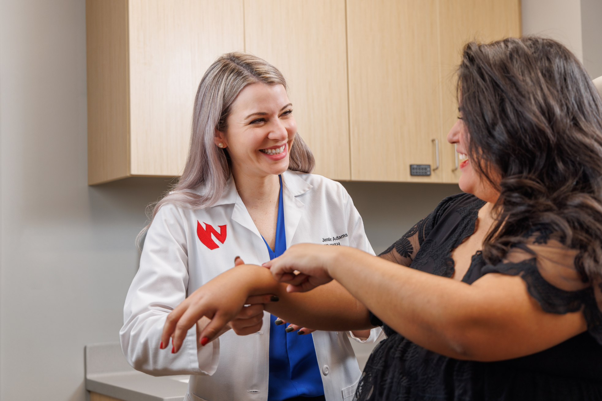 Dr. Adams examines a patient's skin.