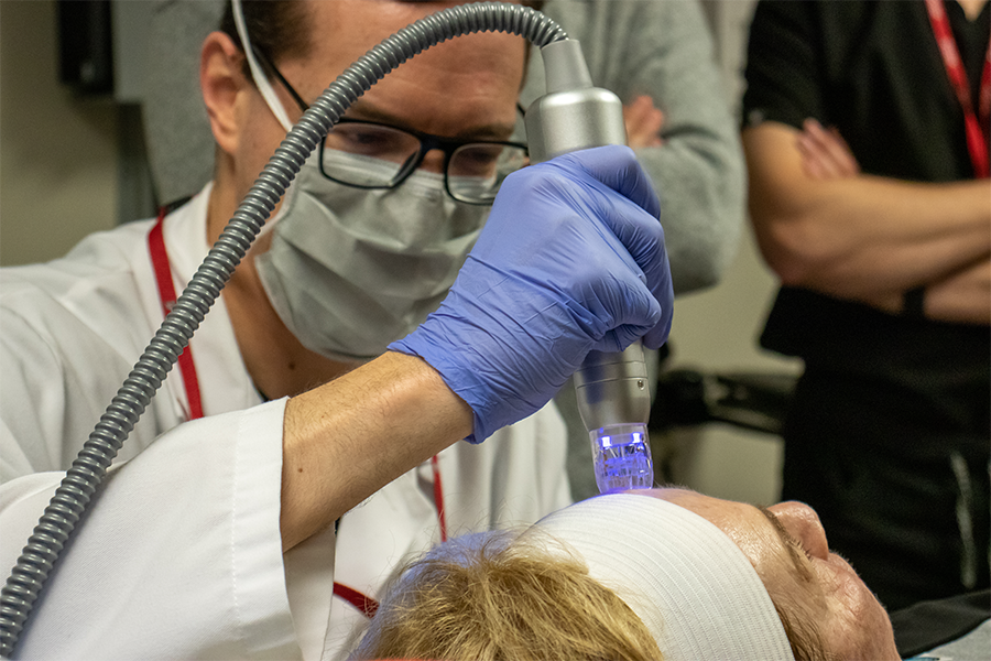 Dr. Sulewski using a laser on a patient.