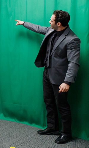 Green screen with person standing in front