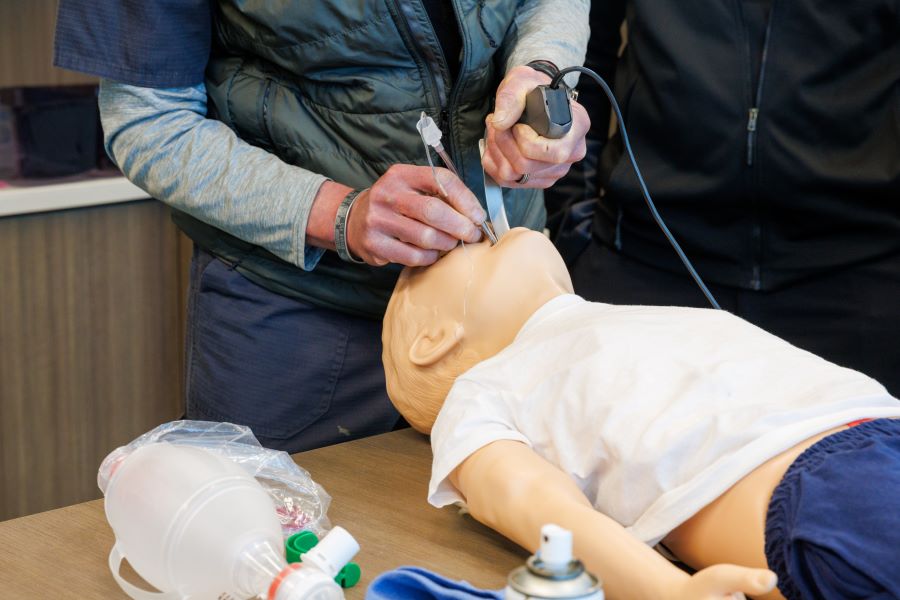 A UNMC faculty member shows program participants best practice for casting an arm. 