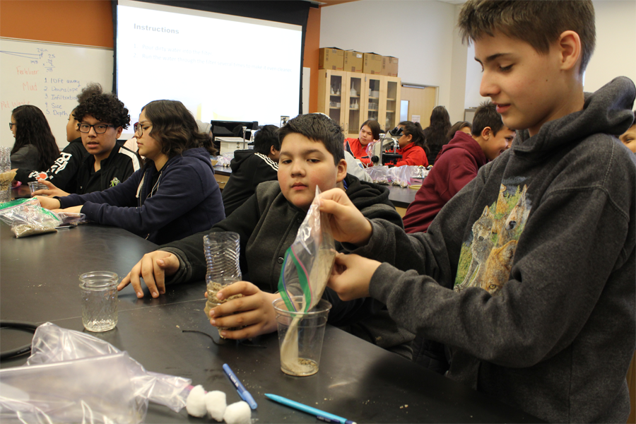 Middle school students participate in a science activity in a learning laboratory