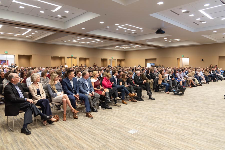A view of 500 guests seated auditorium-style in the Events Center for a presentation.
