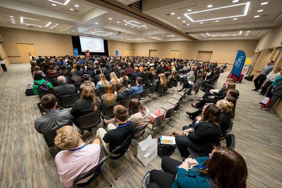 An audience of 500 guests listens to a presentation in the Truhlsen Campus Events Center.