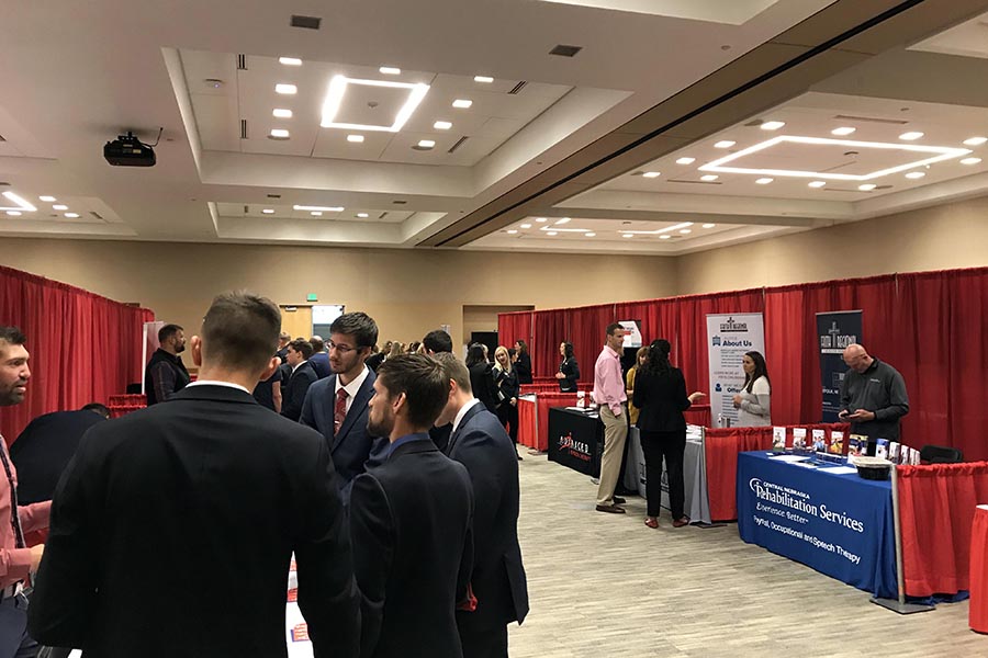 Students networking at a vendor fair in the Events Center.