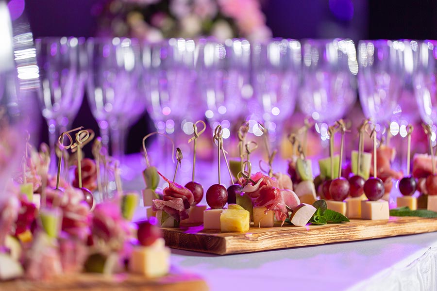 An image of champagne glasses and hors d'oeuvres