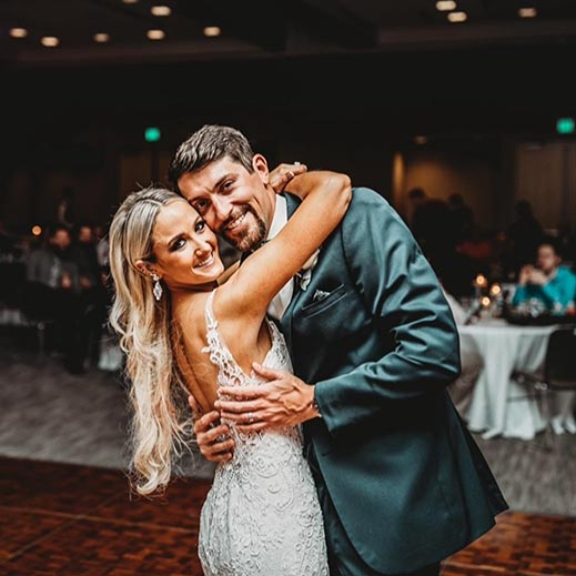 The happy couple poses for a photo on the dance floor.