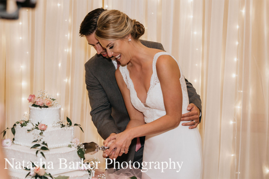 A happy couple cuts the cake at their wedding reception at the Truhlsen Campus Events Center.